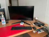 a computer desk with a keyboard and a monitor on it