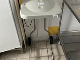 a small table with a sink in the corner of a room