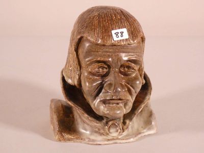 a statue of a man with a sticker on his head