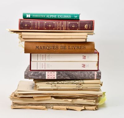 many books stacked on top of each other on a table