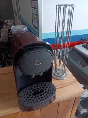 a coffee machine sitting on top of a wooden counter