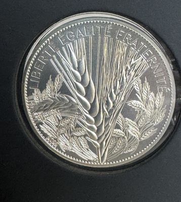 une image représentant une pièce d'argent sur laquelle figure du blé