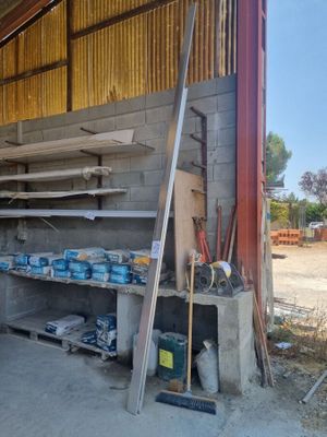 a garage with a lot of shelves and tools in it