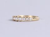 a yellow gold ring with three diamonds on the side