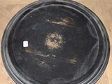 a black tray sitting on a wooden floor next to a wall