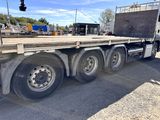 a semi truck with a flat bed on the back of it
