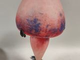 a pink vase with a red and blue design on it