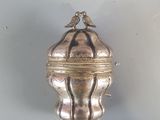 a silver box with a bird on top of it
