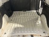 the back of a white van with the bed folded down and the back door open