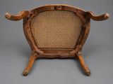 an old wooden chair with wicker seat on a gray background