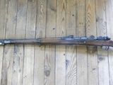 an old rifle on a wooden floor in a room