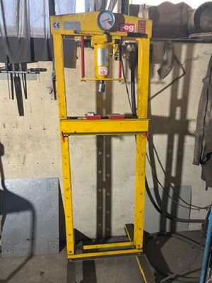 a yellow machine that is sitting in a garage