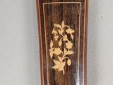 a picture of a wooden object with a flower on it