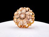 a close up of a gold ring with pearls on a white surface