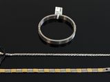 a bracelet, a ring, and a bracelet on a table