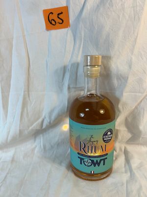 a bottle of rum sitting on a white cloth