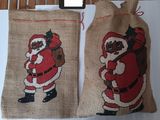 two bags that have santa claus on them on a table