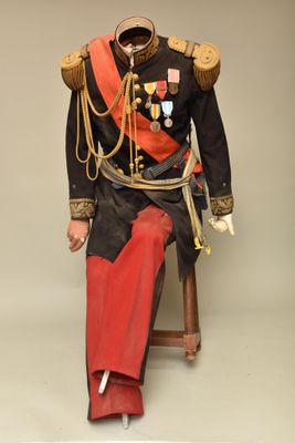 a statue of a man in a military uniform sitting on a chair