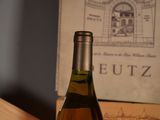 a bottle of wine sitting on a table next to a box of wine
