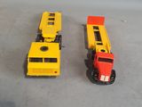 two toy trains sitting next to each other on a table