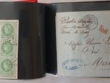 an open book with stamps on it sitting on a table