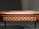 a wooden table with carvings on it in a room