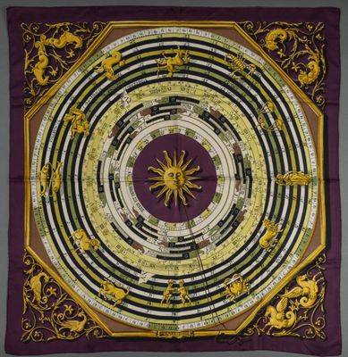 a close up of a square scarf with a circular design on it