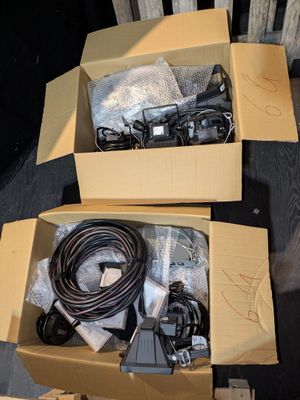 two boxes with wires and cords in them on a table