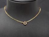 a gold necklace on a mannequin mannequin