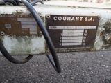 a close up of a rusted out machine with a warrant label on it
