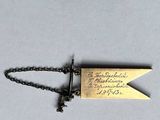 a close up of a small metal object on a chain