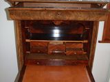 a wooden desk with a marble top and drawers