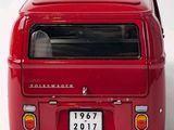 a red van that is parked on a white surface