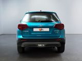 the rear end of a blue suv parked in a room