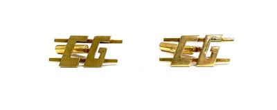 two gold cufflinks on a white background with a white background