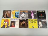 the beatles albums are lined up on a white table