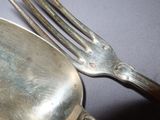 a silver plate with a fork and a spoon on it