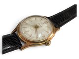 an image of a watch with a gold case and black leather strap