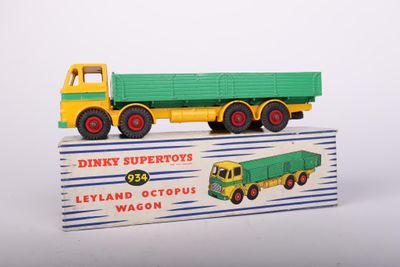 a green and yellow toy truck with a green trailer