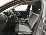 the interior of a car with the door open showing the front seats
