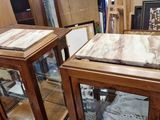 two glass cases with marble on them in a store