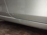 a car that has been painted silver and is parked in a garage