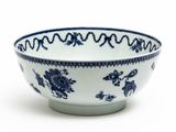 a blue and white bowl sitting on a white surface
