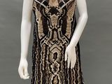 a mannequin wearing a black and gold dress on display