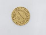 a gold coin with the head of a woman on it