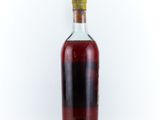 an empty bottle of liquor sitting on a white surface