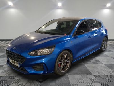 a blue ford focus is parked on a checkered floor