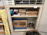 a box of black shoes sitting on the floor in front of a cabinet