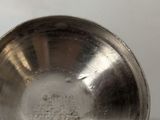 a silver cup that is sitting on a table