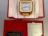 a box with a clock inside of it on a table
